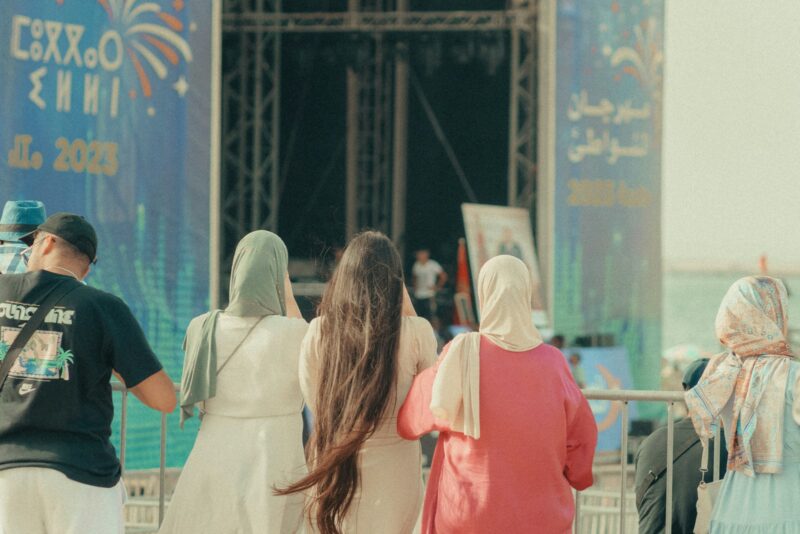 a group of people standing in front of a stage